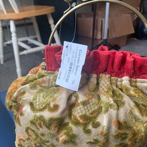 Unique floral Embroidered tapestry hobnob. Unique and has gold metal handle.